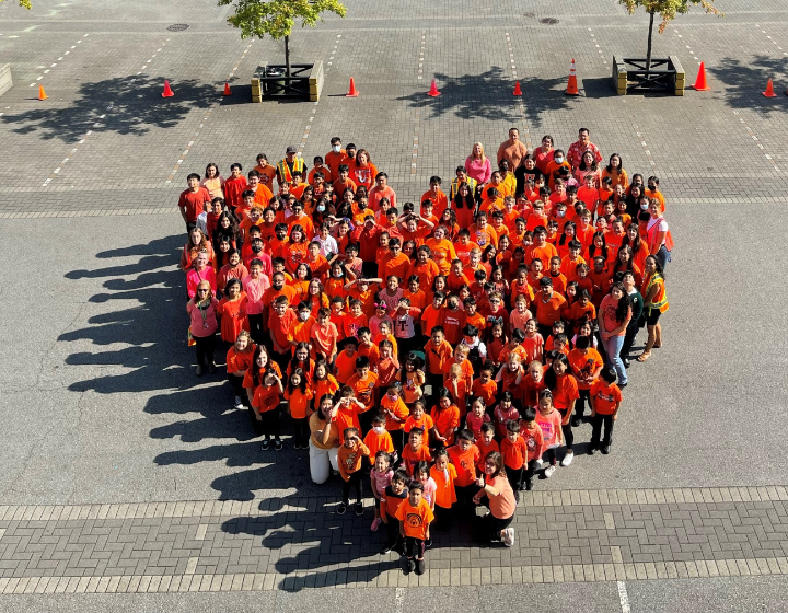 aerial photo of St. Patrick's students dressed in orange shirts grouped in a heart formation