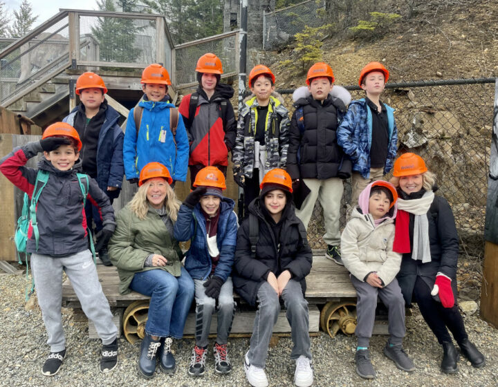 WCRA students and teachers wearing orange hard hats on a field trip