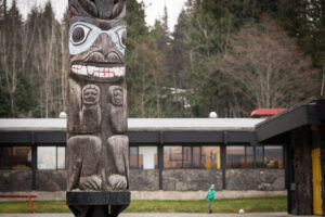 Totem pole in front of a Nisga'a School District office building