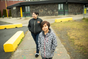 Nisga'a School District 92 teacher and parent standing in front of the school